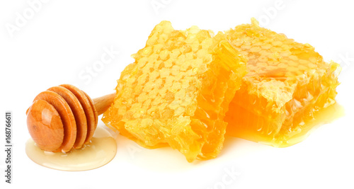 Honeycomb with honey dipper and honey isolated on white background