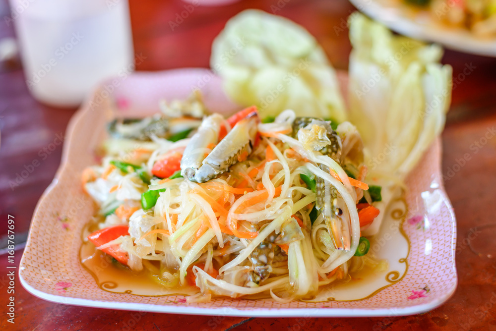 Papaya salad with raw blue crab, Famous traditional spicy thai food, healthy food, Som Tum from Thailand. Papaya salad with raw blue crab, Famous traditional spicy thai food, healthy food, Som Tum from Thailand.