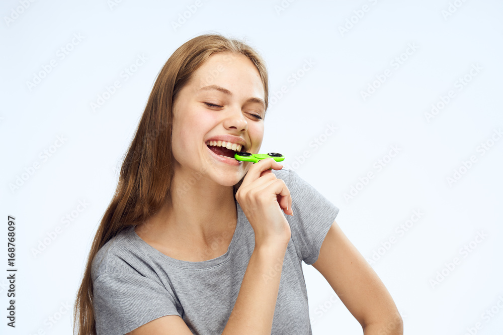 Beautiful young woman on white isolated background, holds a spinner Beautiful young woman on white isolated background, holds a spinner
