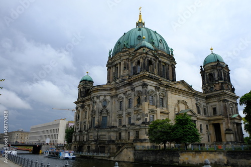 Berlin, Germany - 5 august 2017: Beautiful view of Berliner Dom (Berlin Cathedral) at famous Museumsinsel (Museum Island) with excursion boat on Spree river in Berlin, Germany