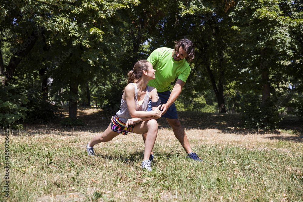 Fototapeta premium Young couple having exercise in the park