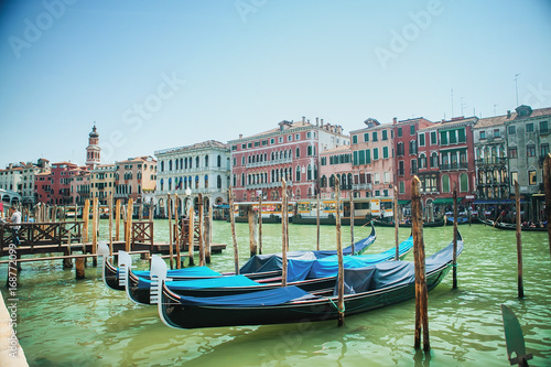 VENICE, ITALY - APRIL 23, 2017. Covered gondolas at the Grand Canal promenade © Watercolor_Art_Photo