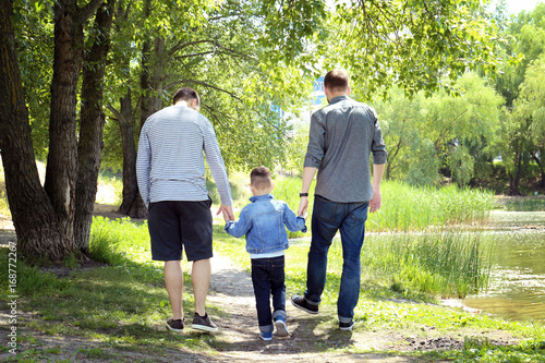 Gay couple with son in park photo