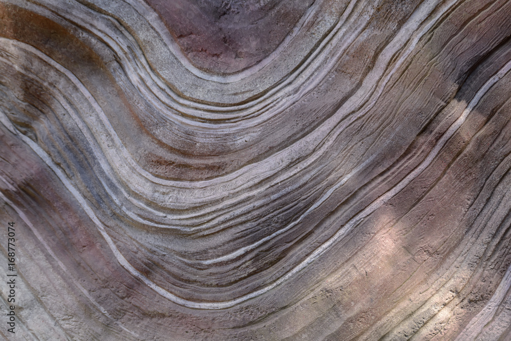 Background texture of wavy curvy lines on a huge stone Background texture of wavy curvy lines on a huge stone
