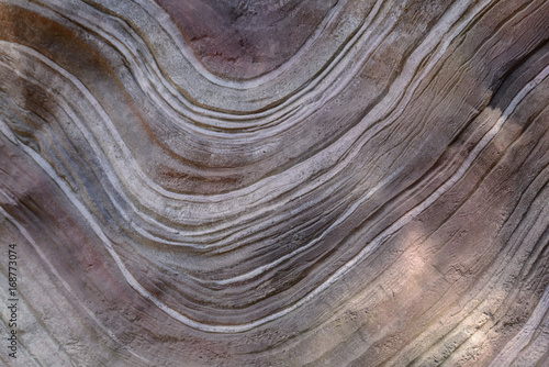 Background texture of wavy curvy lines on a huge stone