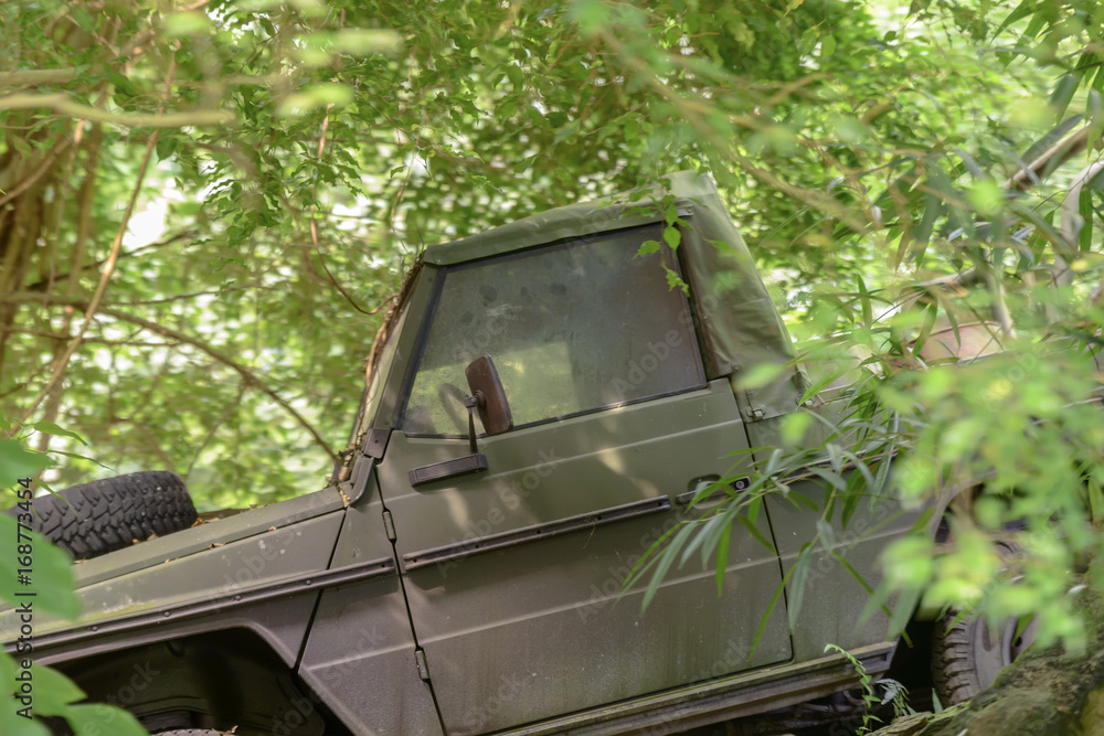 Abandoned old SUV in impenetrable tropical jungle