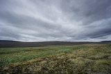 Iceland - Dark atmosphere at lonely flat landscape of volcanic origin
