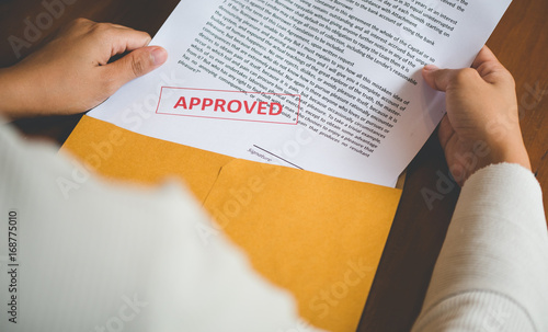 Women are opening an envelope document about signing a contract in business and sign contract concept,vintage style . photo