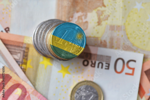 euro coin with national flag of rwanda on the euro money banknotes background.