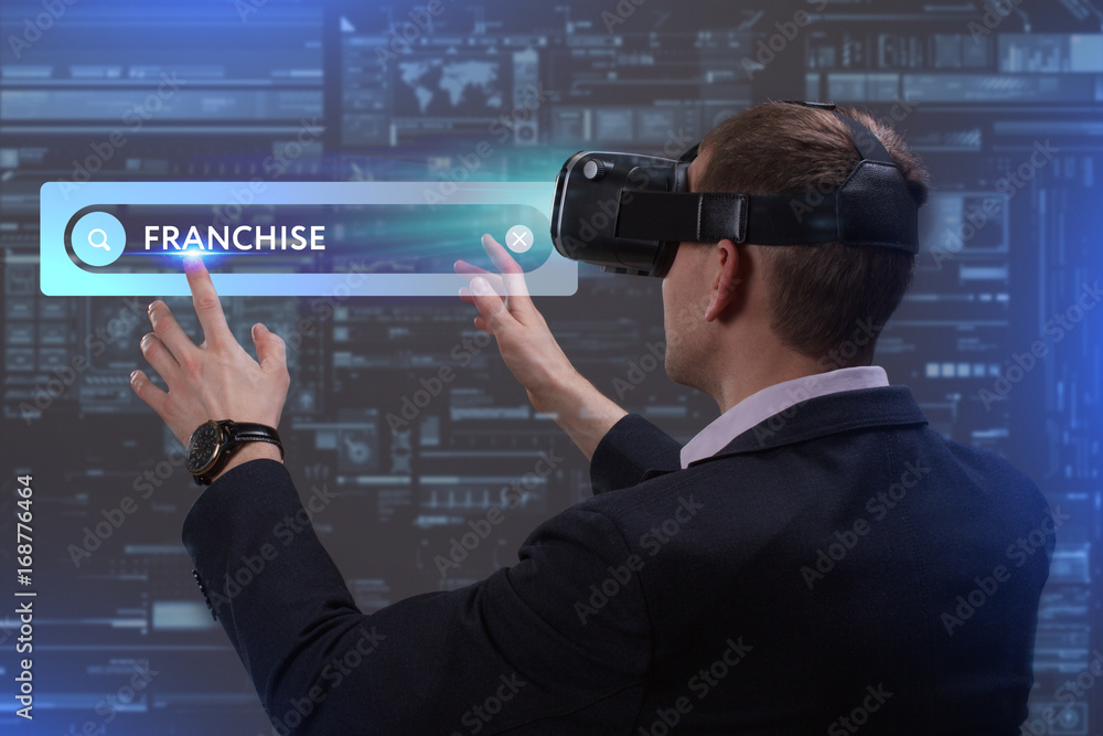 Business, Technology, Internet and network concept. Young businessman working on a virtual screen of the future and sees the inscription: Franchise Business, Technology, Internet and network concept. Young businessman working on a virtual screen of the future and sees the inscription: Franchise
