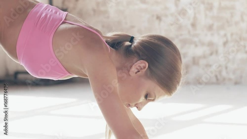 Slow-motion shooting exercises Yoga close-up. Sporty girl doing exercises on mate. Magnificent stretching and stability of the t photo