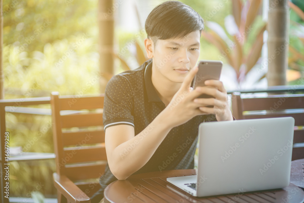 Businessman working laptop for new architectural project, sitting at table in cafe and uses laptop.Nearby is smartphone. Generic design notebook on the table. Freelancer working outside office