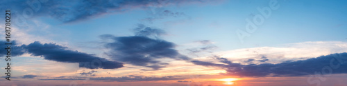 Vibrant color panoramic sun rise and sun set sky with cloud on a cloudy day. Beautiful cirrus cloud. Panorama high resolution photograph. © tanarch