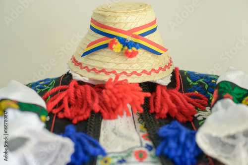 Romanian traditional male costume with ornate blouse or shirt and straw hat with tricolor, specific to the northern part of the country, from Tara Oasului - Oas Country, Maramures, Romania