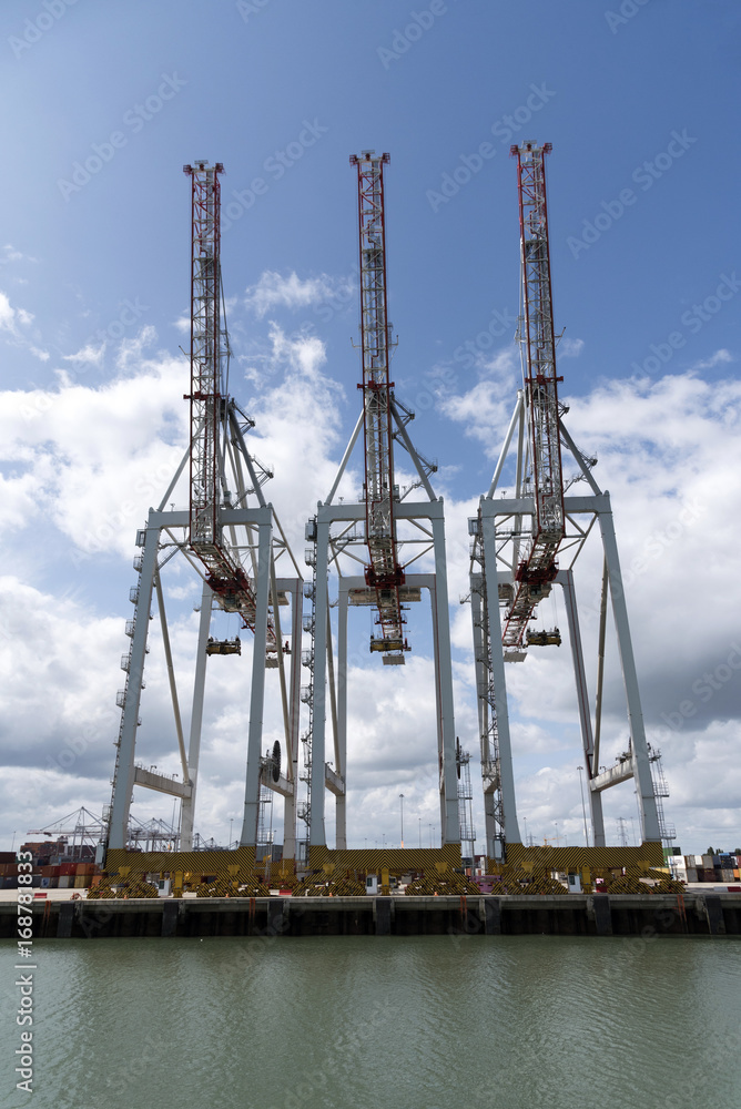 Thre cranes line the waterfront at D P World Container Terminal in Southampton Docks England UK. August 2017 Thre cranes line the waterfront at D P World Container Terminal in Southampton Docks England UK. August 2017