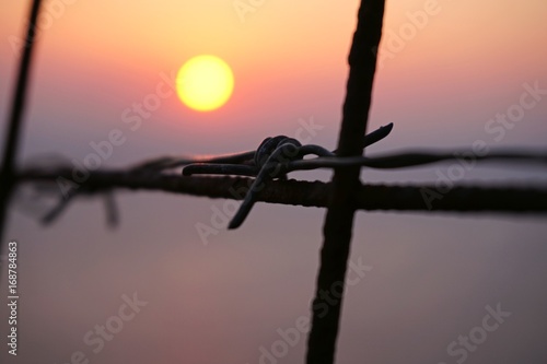 Sunset under barbed wire