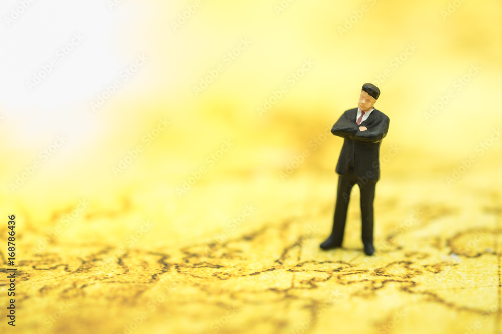 Close up of businessman miniature people figure standing and planning on world map. Using as global worldwide business and management concept. Close up of businessman miniature people figure standing and planning on world map. Using as global worldwide business and management concept.