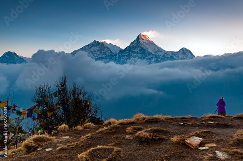 Unidentified person taking photo of Annapurna mountain range at Poon Hill view point in Nepal. Poon Hill is a popular destination for trekkers in the Annapurna region of Nepal. photo