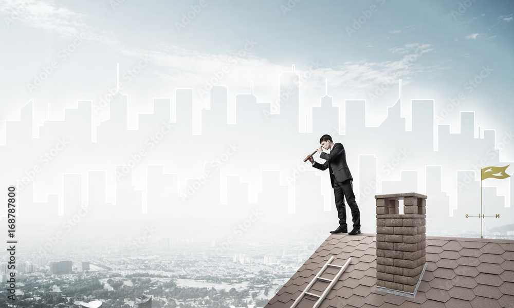 Engineer man standing on roof and looking in spyglass. Mixed med Engineer man standing on roof and looking in spyglass. Mixed med