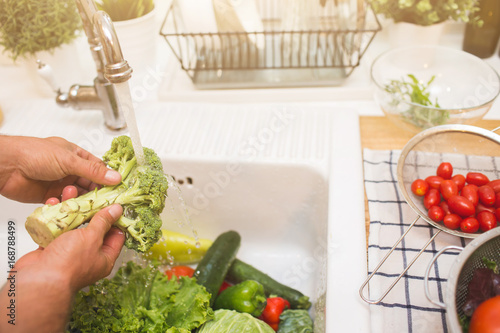 Man washes vegetables before eating photo