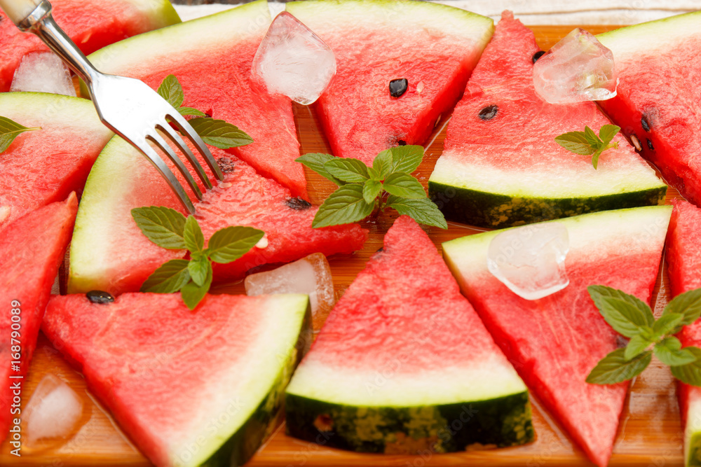 Slices of fresh watermelon with ice and mint. Selective focus