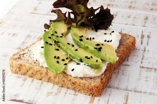 Sandwich with avocado and sesame - healthy breakfast concept