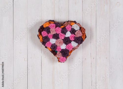 Fototapeta Naklejka Na Ścianę i Meble -  Heart symbol made of flovers .White wooden background