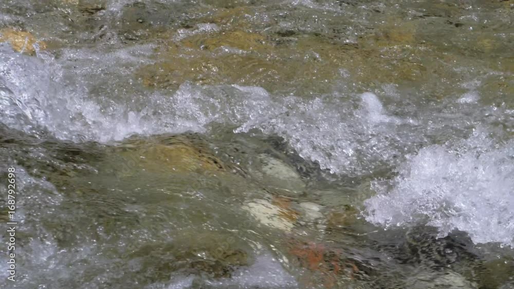 Water in a mountain river in slow motion video. Water in a mountain river in slow motion video.