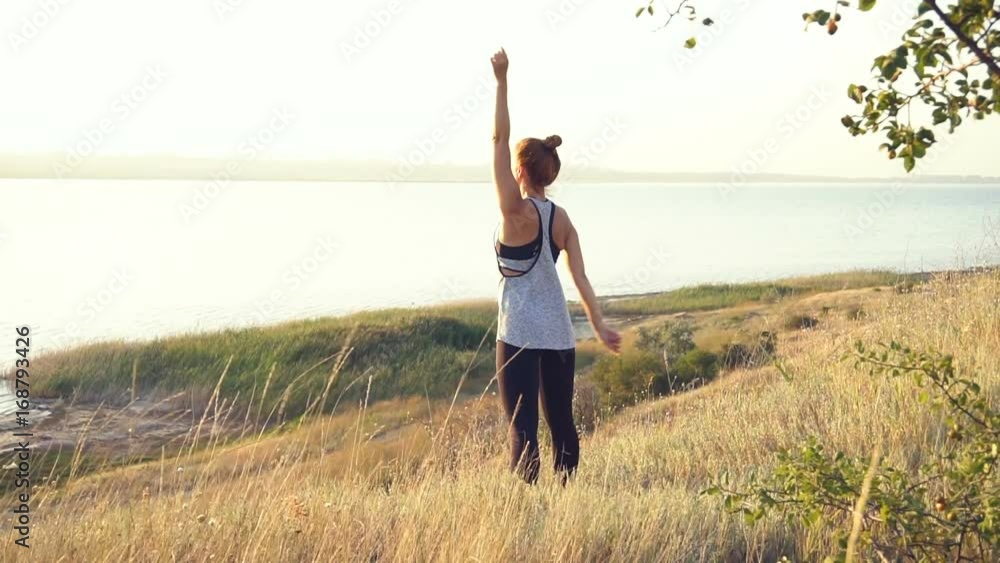 Happy young woman practicing yoga on the beach at sunset Happy young woman practicing yoga on the beach at sunset