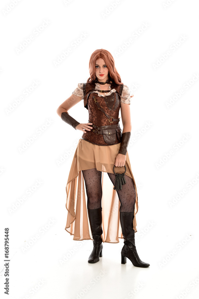 full length portrait of a red haired lady, wearing a steampunk inspired outfit, isolated  on white background.