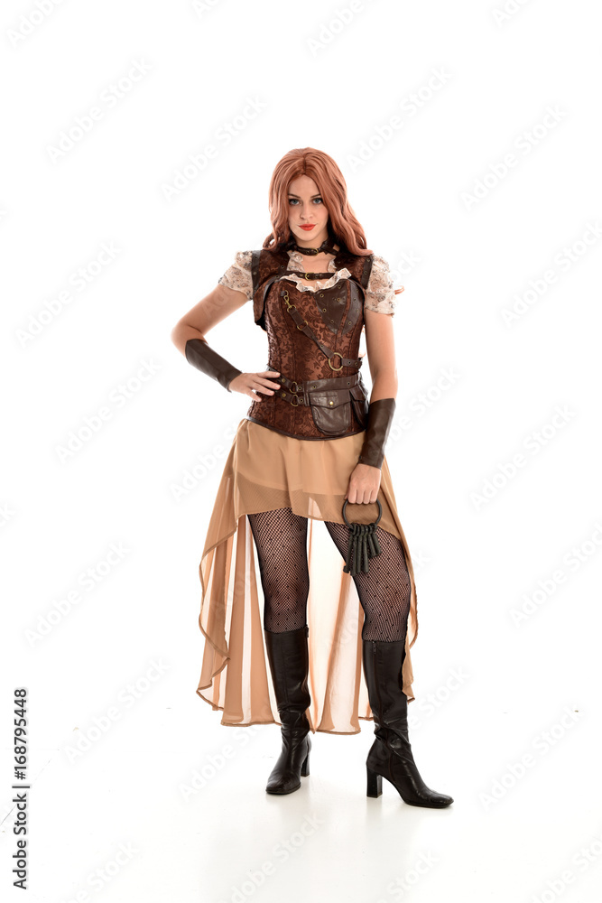 full length portrait of a red haired lady, wearing a steampunk inspired outfit, isolated on white background. full length portrait of a red haired lady, wearing a steampunk inspired outfit, isolated on white background.