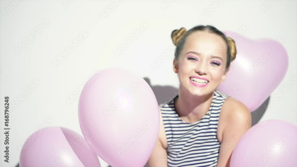 Beauty girl with colorful air balloons dancing and laughing. Happy young woman on birthday holiday party. Slow motion 240 fps. 4K UHD video 3840x2160 Beauty girl with colorful air balloons dancing and laughing. Happy young woman on birthday holiday party. Slow motion 240 fps. 4K UHD video 3840x2160