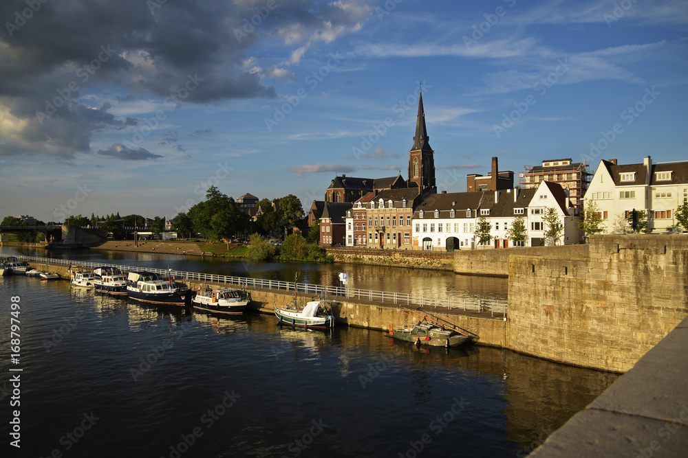 Maastricht, the Dutch city on the river Maas with boats in the harbor and the Sint Martinuskerk church in the old town, Netherlands, Europe