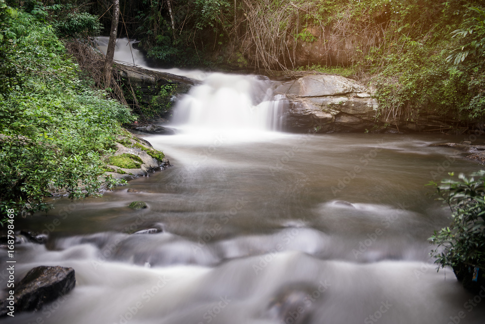 waterfall in deep forest with sunlight waterfall in deep forest with sunlight