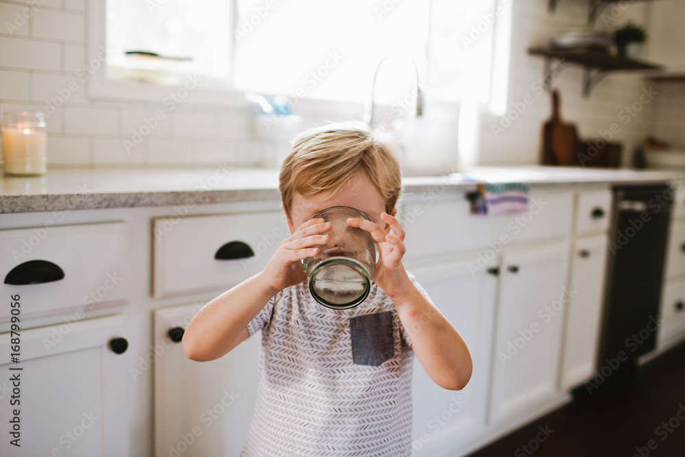 Boy drinking in kitchen Boy drinking in kitchen