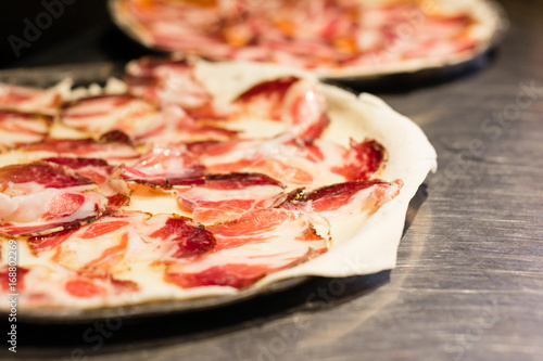 Simple traditional pizza with capocollo Italian salami photo