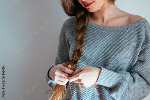 Detail of woman making a braid