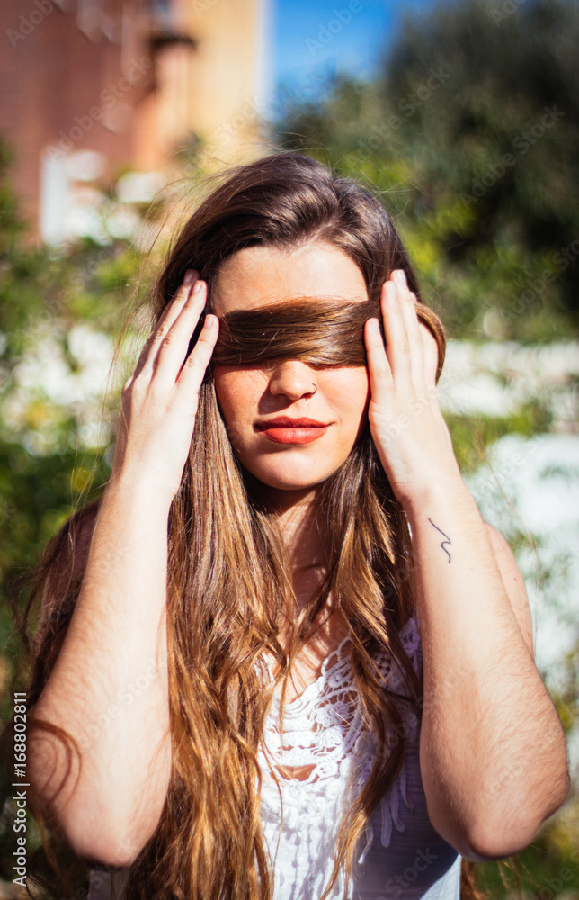 Portrait of woman covering her eyes with her hair Portrait of woman covering her eyes with her hair