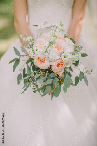 Wedding bouquet in hands of the bride