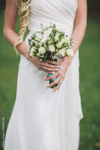 Wedding bouquet in hands of the bride