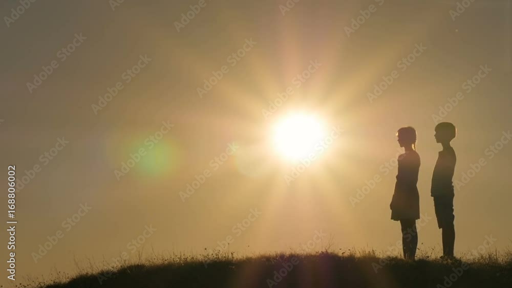 Silhouettes of children against the sky and sun. Backlight. Silhouettes of children against the sky and sun. Backlight.