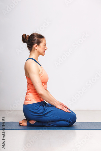 Woman in Hatha yoga asana Vajrasana photo