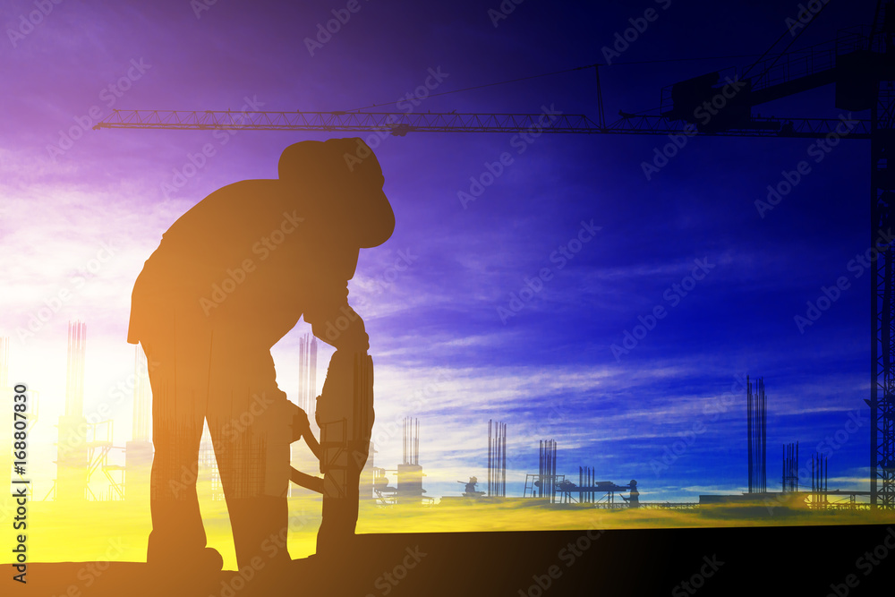 Fototapeta premium Double exposure of silhouette construction worker