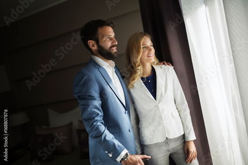 Picture of businessman and businesswoman in hotel room