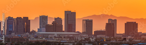 skyline of downtown Phoenix Arizona shot from Sky Harbor Airport with the famous Camelback Mountain at sunset