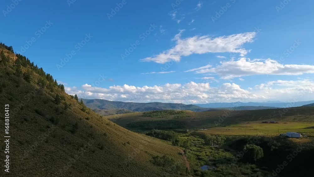 Aerial flight over a small mountain with mountains in the background. Aerial flight over a small mountain with mountains in the background.