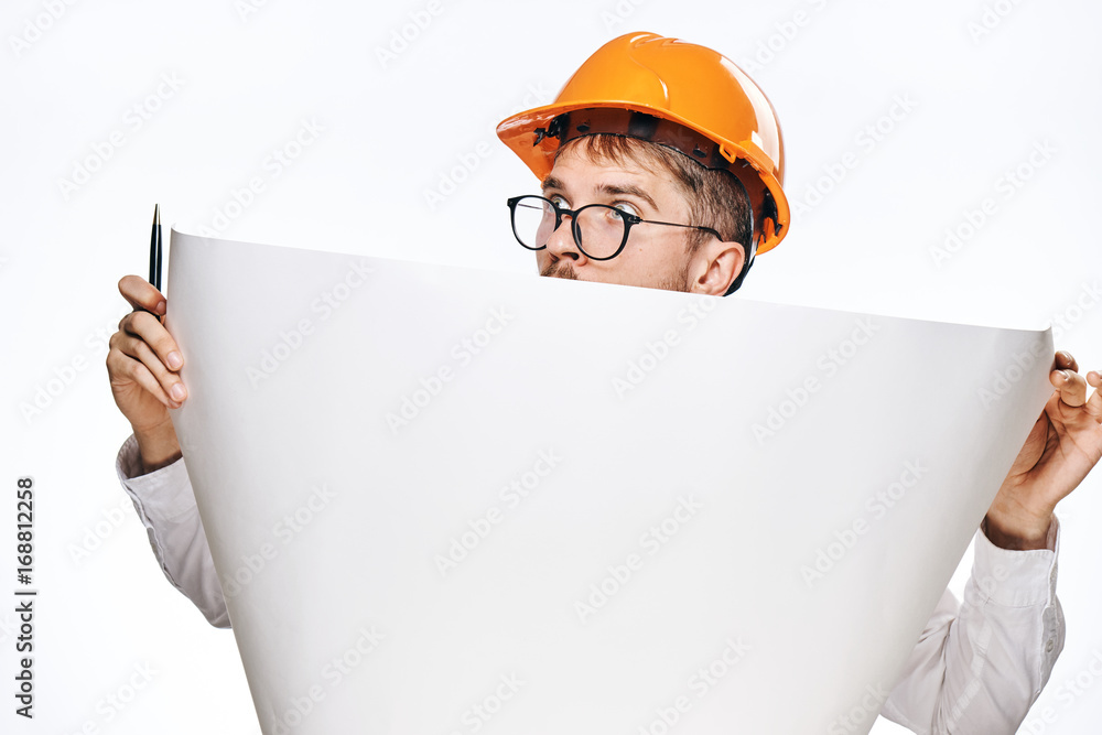 Engineer man with a beard on a white isolated background holds a drawing Engineer man with a beard on a white isolated background holds a drawing
