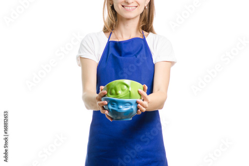 Beautiful girl in apron with plates in hands