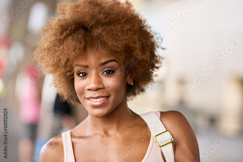 portrait of happy african american woman at airport ready to depart for flight