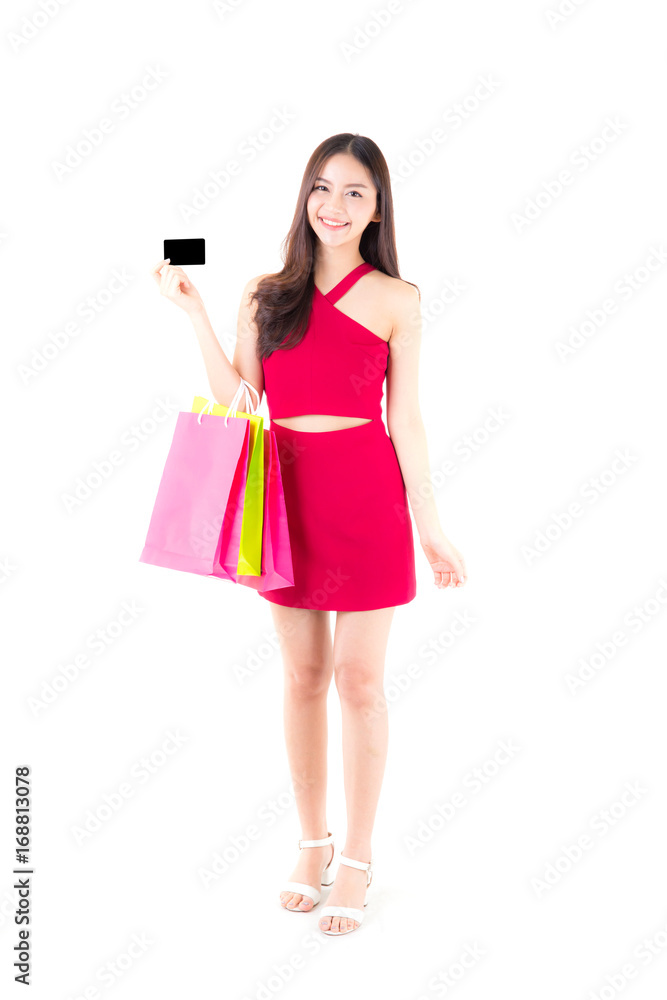 Asian young woman with red dress holding a credit card and bag paper colorful isolated on white background. Asian young woman with red dress holding a credit card and bag paper colorful isolated on white background.